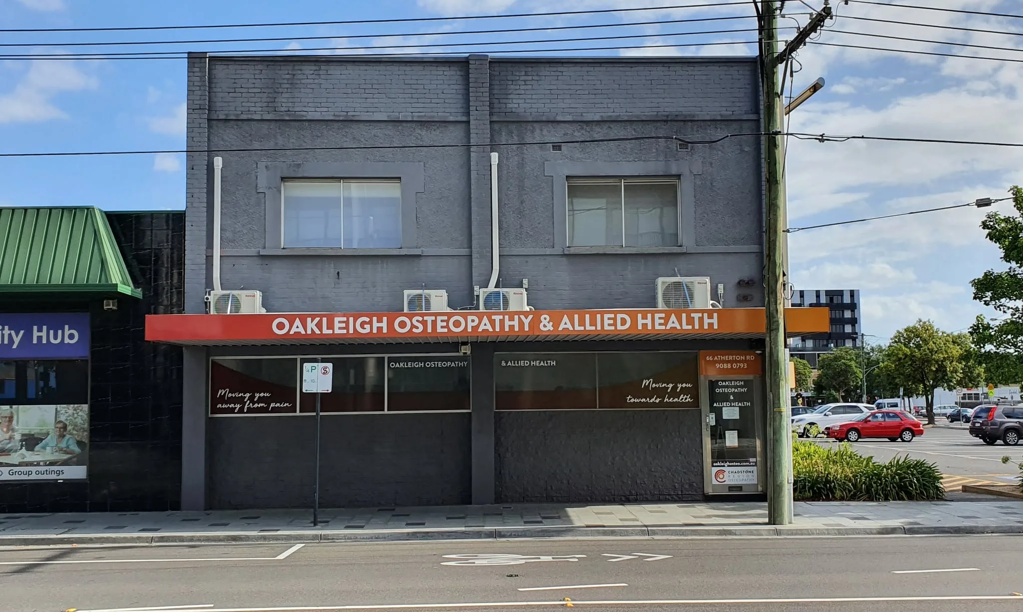 Street exterior of the host building at 66 Atherton Road, Oakleigh — orange Oakleigh Osteopathy and Allied Health awning